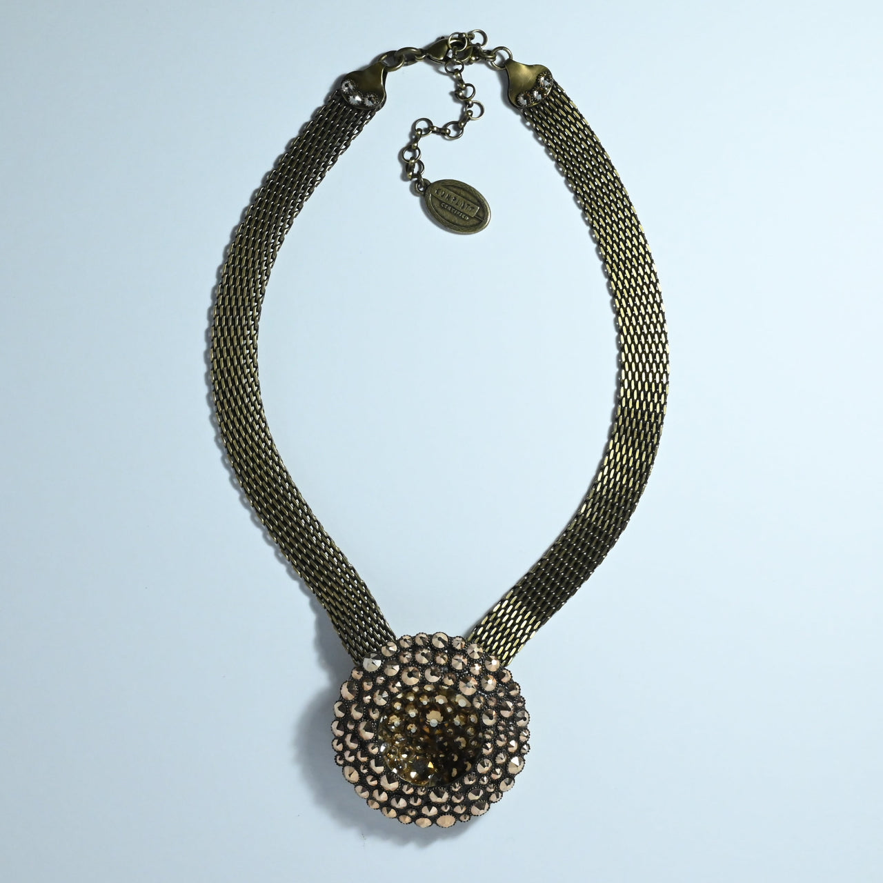 Wonderful statement necklace for Konplott by German Designer Miranda Konstantinidou .  With bronze coloured mesh metal hardware and bronze faceted stones in a large round centre piece.  Measures 40cm + 9cm extension chain .