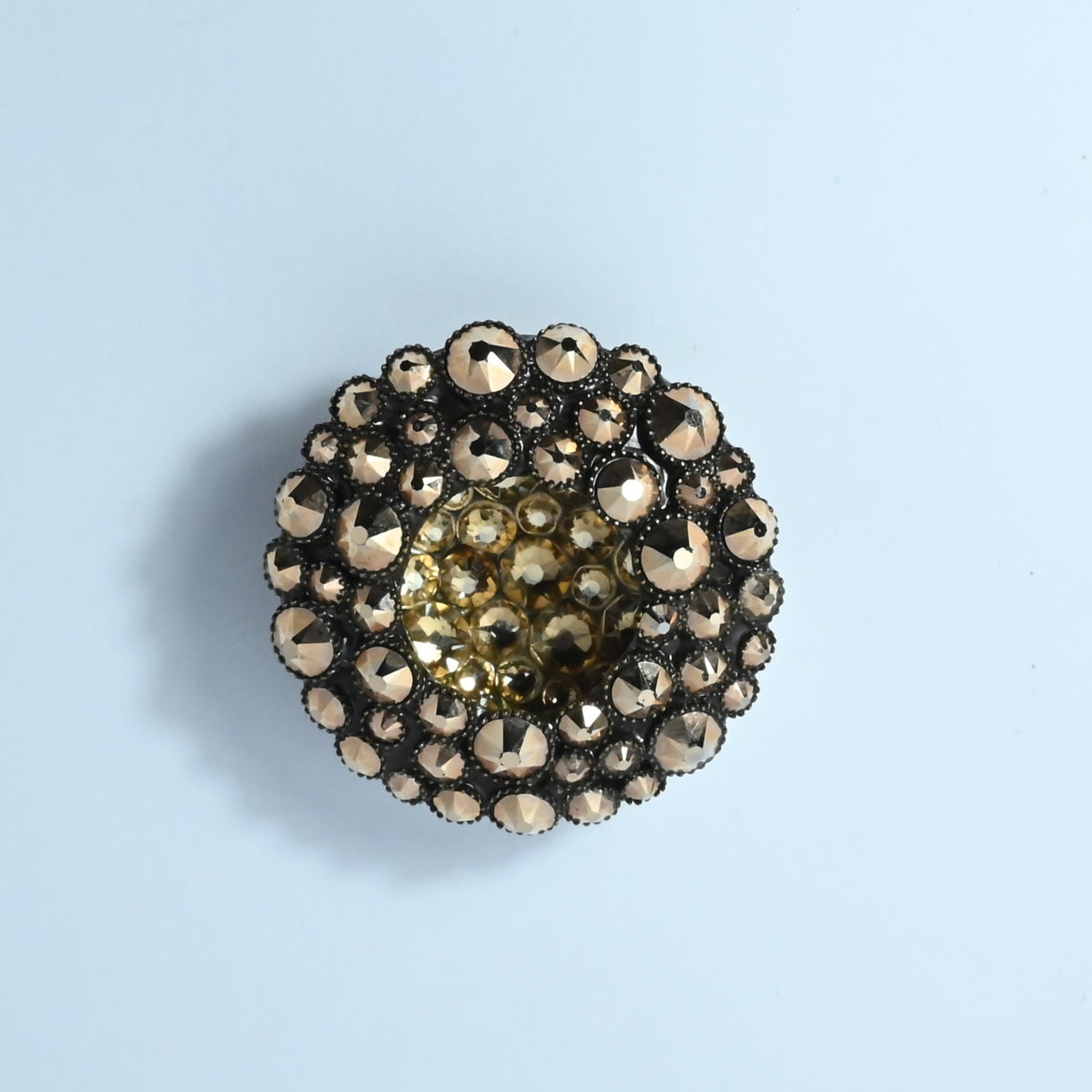 Statement ring by Konplott of Germany by designer Miranda Konstantinidou.&nbsp; In bronze plated metal with faceted brown rhinestones this ring is free size with a large circular centrepiece.&nbsp;