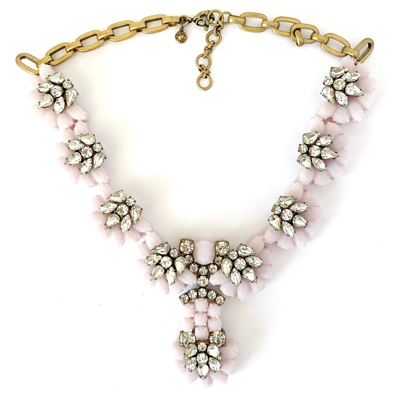 Fantastic mixed media J Crew statement necklace made of a pale pink rubber with matt gold plate hardware and clear super reflective claw set rhinestones 